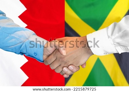 Business handshake on background of two flags. Men handshake on background of Bahrain and Jamaica flag. Support concept