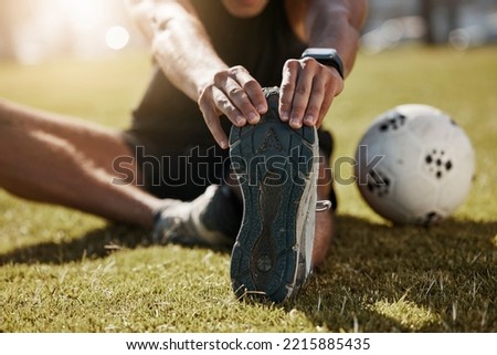 Stretching, foot and soccer man on field for sports training, exercise wellness or legs muscle health. Professional football person with sneakers or shoes for game warmup, workout outdoor on a pitch Royalty-Free Stock Photo #2215885435