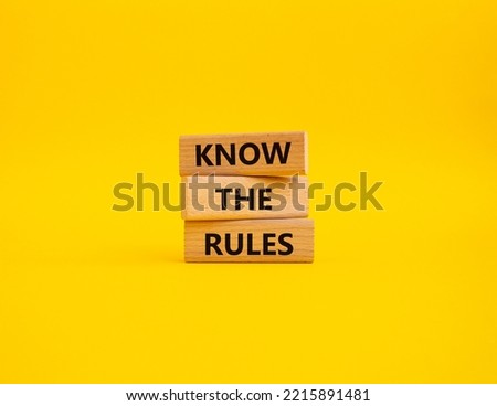 Know the rules symbol. Wooden blocks with words Know the rules. Beautiful yellow background. Business and Know the rules concept. Copy space.