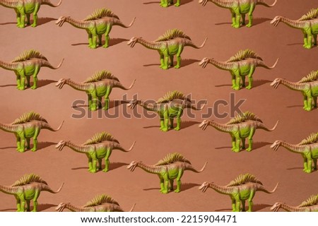 Brown green spiny dinosaur on a dirty brown background. Pattern. Minimal design.