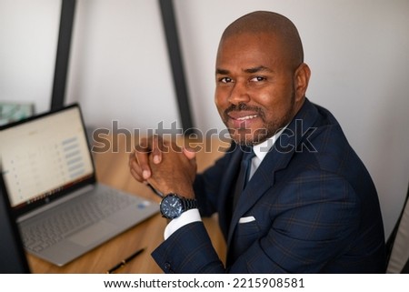 
A black man works at a computer. Doing business.
Young businessman working on a computer in an office..