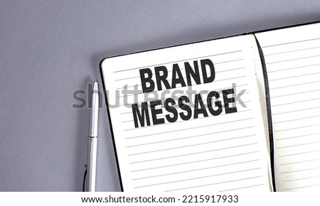 BRAND MESSAGE word on notebook with pen