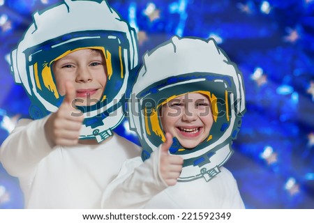 Portrait of two smiling kids in space suits. Cosmonautics Day concept.