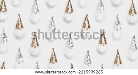 Christmas minimal pattern with cute dwarfs. Winter happy holiday concept. New Year toys dwarf in sparkle cap silver and golden colored on white background.  Minimalist flat lay banner, trend pattern
