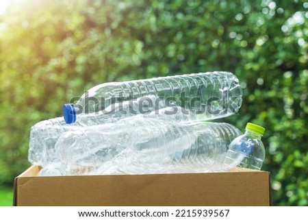 plastic bottle in paper box for concept recycling and reuse in the garden.