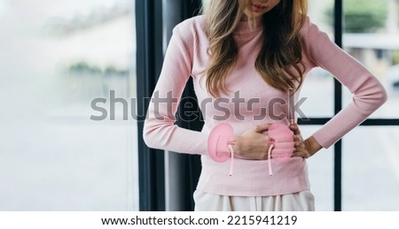 Woman suffering stress and her touching on virtual kidney shape, chronic kidney disease, renal failure, dialysis, Healthy feminine concept. Royalty-Free Stock Photo #2215941219