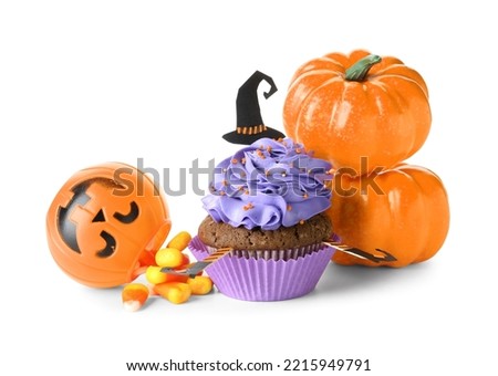 Tasty Halloween cupcake with pumpkins and candies on white background
