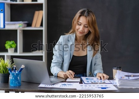business woman working in office with laptop and working finance graph document Review and calculate financial costs annual balance sheet financial balance sheet