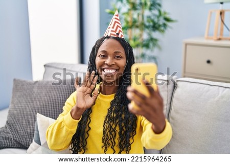 African american woman having video call celebrating birthday at home