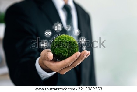 Businessmen holding world to Organization Sustainable development environmental. Sustainable business or green company Concept. business responsible environmental, social and governance. Royalty-Free Stock Photo #2215969353