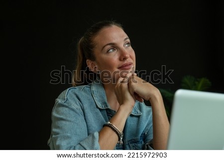 Girl working on laptop in trendy coffee shop - stock photo