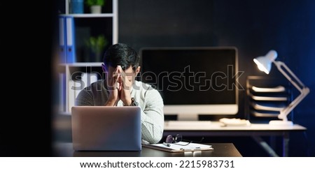 Stressed business man working over time at night. business account and finance concept Royalty-Free Stock Photo #2215983731