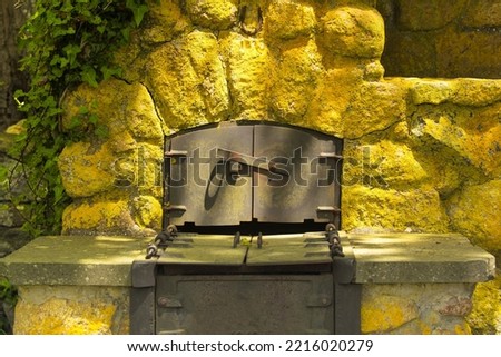 An outside metal oven and yellow stone fireplace in a park on Martha's vineyard massachusetts. 