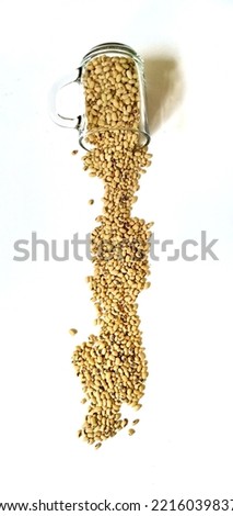 Spilled Black Eyed Peas over a white background. Picture of raw Black Eyed Peas (beans) spilled from glasses over on white background.