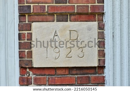 Cemetery sign A.D. 1923. Year built signage on old brick wall
