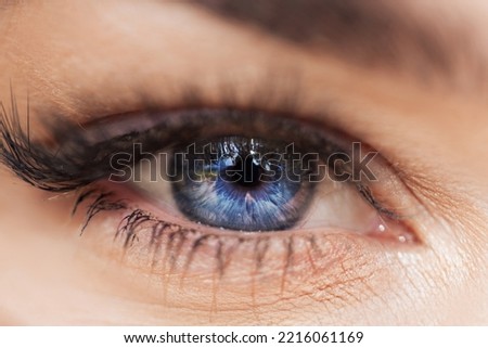 Amazing blue female eye, macro. Beautiful charming eye texture with light and depth.