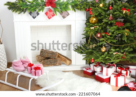 Fireplace with beautiful Christmas decorations in room