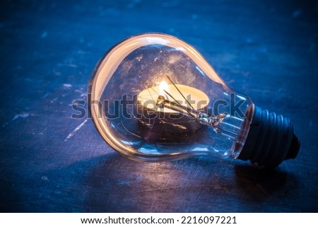 Glass lamp on the background of a candle. Blackout in Ukraine due to war Royalty-Free Stock Photo #2216097221