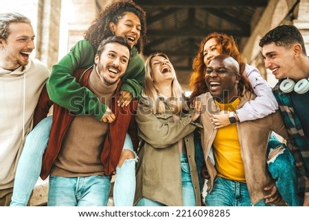 Happy multiracial best friends having fun hanging on city street - Group of young people laughing together walking outside - College students talking and smiling in college campus - Friendship concept