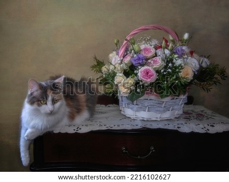 Basket of flowers and pretty tricolor kitty