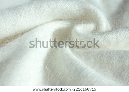 Background fabric texture of Angora. Background texture of white pattern knitted fabric made of cotton or wool or angora close up. Royalty-Free Stock Photo #2216168915