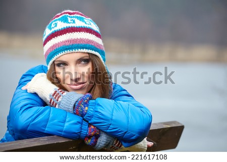 Smiling beautiful young woman relaxing outdoor in a winter day 