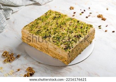 pistachio cake on white marble table side view
