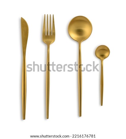 Golden coloured cutlery set with Fork, Knife, Spoon and tea spoon isolated on white background. Clipping path included. Royalty-Free Stock Photo #2216176781