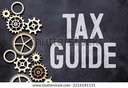 hand writing inscription tax guide with red color marker, concept, stock image.