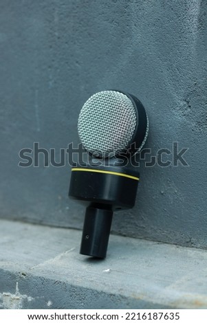 silver and black mic with gray background