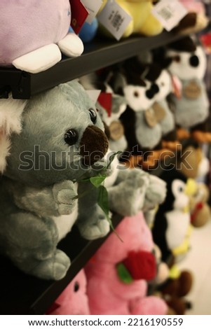 cute koala doll on doll shelves inside supermarket for child play