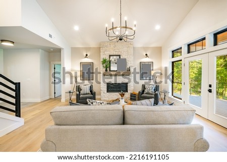 interior home living room with warm decor staged staircase and furnishings Royalty-Free Stock Photo #2216191105