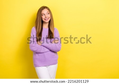 Photo of young attractive teenager schoolgirl minded looking empty space advertisement minded choosing new clothes isolated on bright yellow color background