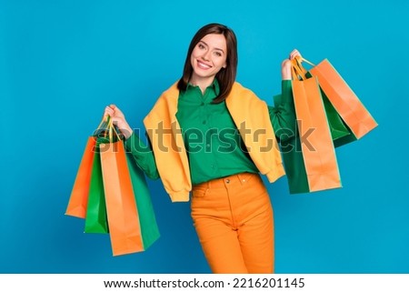 Photo of nice cheerful person hands hold raise boutique packages isolated on blue color background
