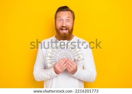 Photo of astonished person hands hold dollar banknotes bills isolated on yellow color background