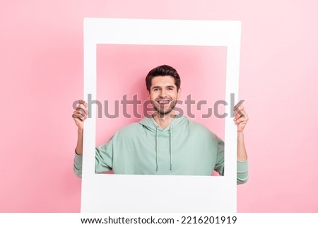 Photo of cheerful person hands hold paper album card toothy smile isolated on pink color background