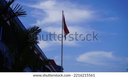 Indonesian Flag Under the Blue Sky