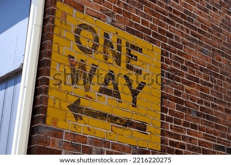 One way sign on the brick wall