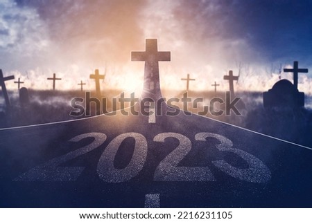 Image of 2023 number with Cross symbol at end road in the cemetery background