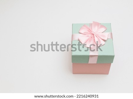 Pink and blue gift box with bow on white background with copy space happy festival images