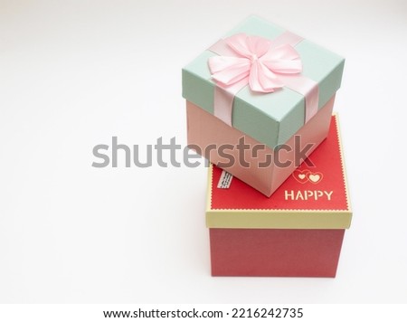 stacked red and pink gift boxes tied with bows on a white background happy festival images