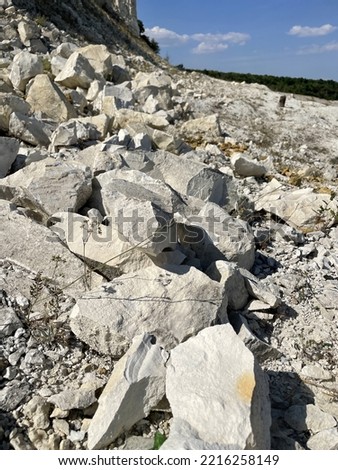 large vertical photo. chalk mountains. mineral resource. large pieces of chalk stones. natural Park. close-up of chalk debris.