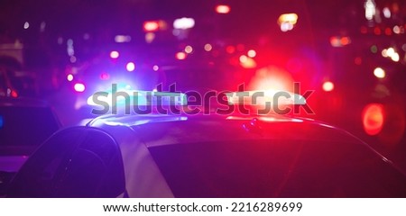 Red and blue light flasher. Police car at night time in the city Royalty-Free Stock Photo #2216289699