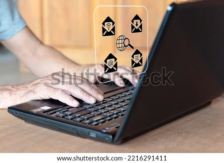 Close-up of man typing on laptop computer with icon effect. Royalty-Free Stock Photo #2216291411