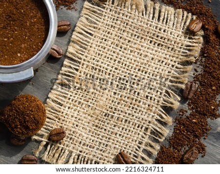 Coffee cone with ground coffee lie on coffee beans on burlap. Menu of coffee drinks.