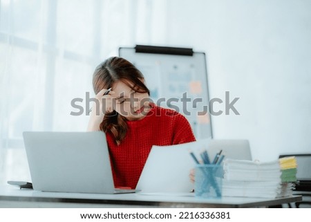 Asian women are stressed while working on laptop, Tired asian businesswoman with headache at office, feeling sick at work, copy space Royalty-Free Stock Photo #2216336381