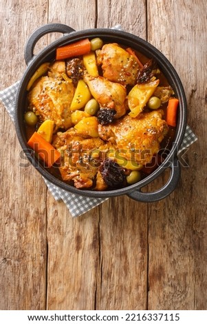 Gallo en chicha Salvadoran chicken braised in fizzy and tangy pineapple chicha with vegetables closeup on the pan on the wooden table. Vertical top view from above
 Royalty-Free Stock Photo #2216337115