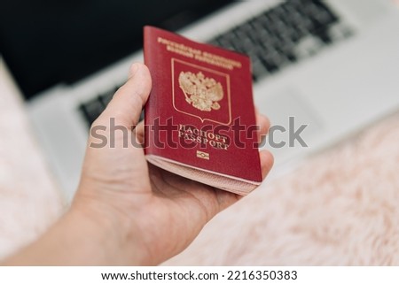 Russian foreign international passport in the hand citizen. Russian citizenship, passport and rights concept.