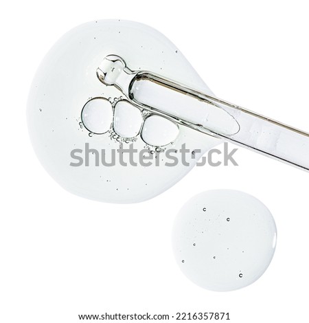Pipette and drops of cosmetic serum for the skin. Liquid body care product. Isolated on a white background. Royalty-Free Stock Photo #2216357871