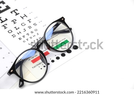 Eyeglasses frame with chart on white table. eye test, trial frame eyewear Royalty-Free Stock Photo #2216360911